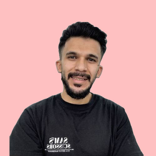 Almo, barber at Sam's Scissors
