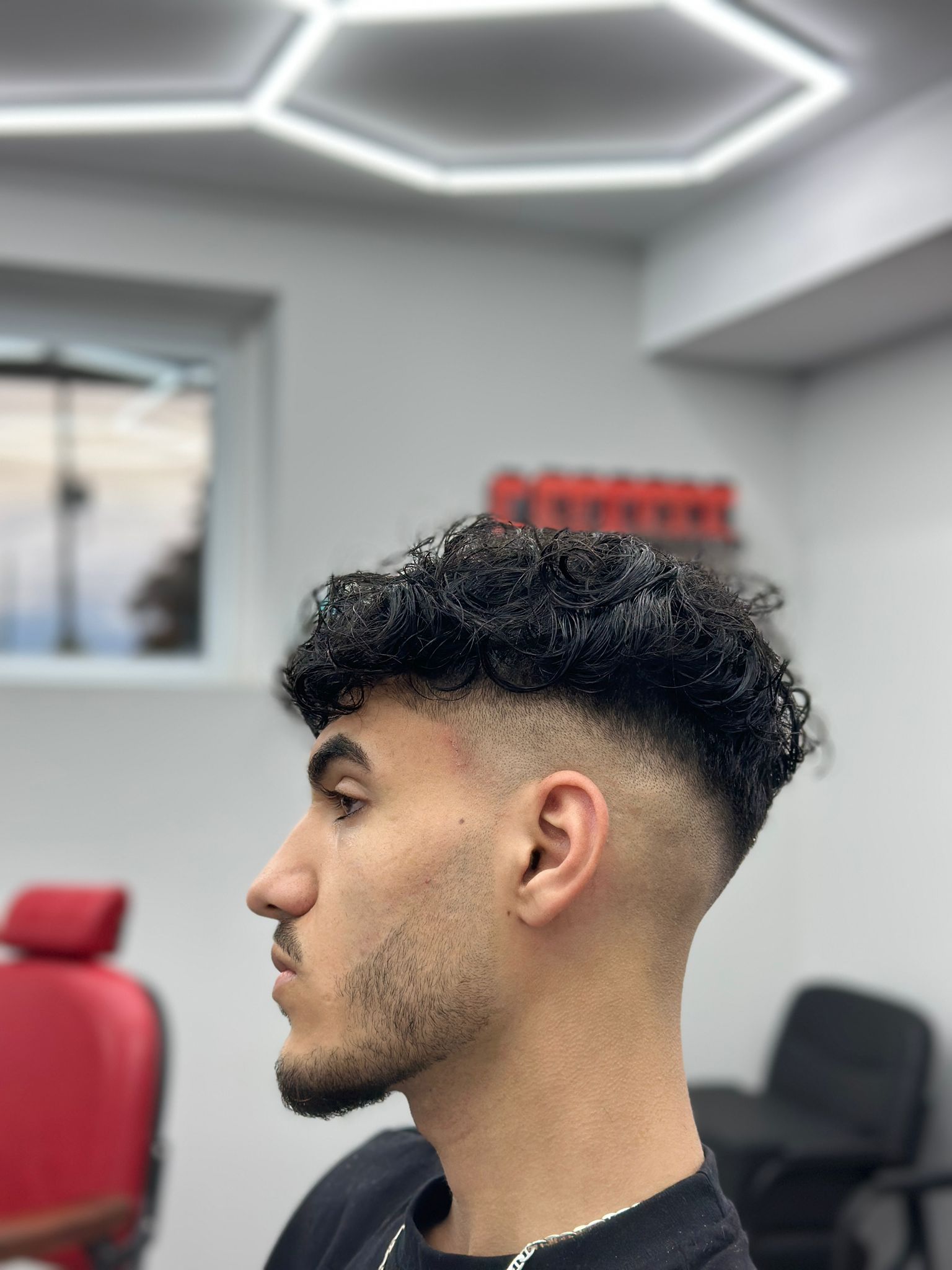 Clean taper fade and line-up at Sam's Scissors