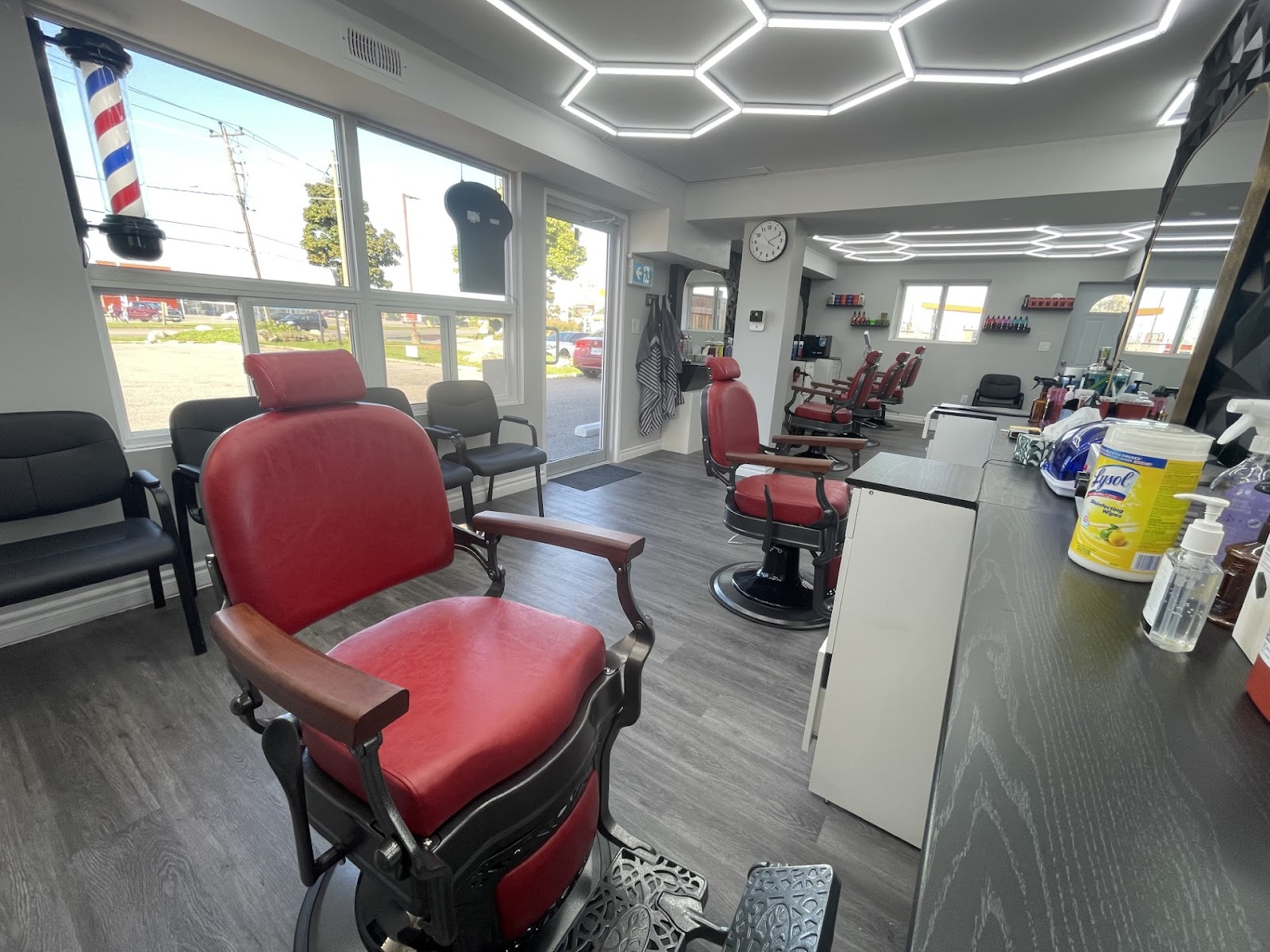 Inside Sam's Scissors Barbershop, red vintage chairs and modern lighting